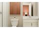 Modern bathroom features a white vanity, matching toilet, shower and accent art at 9657 Runaway Breeze Dr, Land O Lakes, FL 34637