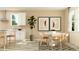 Bright dining area featuring modern decor, a round table, and large windows for ample natural light at 9657 Runaway Breeze Dr, Land O Lakes, FL 34637
