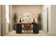 Stylish home office featuring a modern desk, round accent mirror and natural light at 9657 Runaway Breeze Dr, Land O Lakes, FL 34637