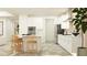 Bright, open kitchen with modern appliances, a large island, white cabinets, and modern flooring at 9657 Runaway Breeze Dr, Land O Lakes, FL 34637
