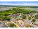 Scenic aerial view of apartment complex featuring a pool, parking and lush green landscape near a lake at 10100 Sailwinds N Blvd # 105, Largo, FL 33773