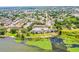 Wide aerial view of the community buildings near a lake, lush greenery, and scenic surroundings at 10100 Sailwinds N Blvd # 105, Largo, FL 33773