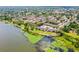 Aerial shot of lakeside apartments with parking, green spaces, and water access at 10100 Sailwinds N Blvd # 105, Largo, FL 33773