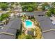 Overhead shot of complex with a swimming pool, lounge chairs and umbrellas at 10100 Sailwinds N Blvd # 105, Largo, FL 33773