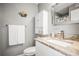 Neat bathroom featuring a sink with granite countertop, cabinet, and mirrored medicine cabinet at 10100 Sailwinds N Blvd # 105, Largo, FL 33773
