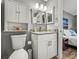 Cozy bathroom with granite countertop vanity and mirrored medicine cabinet with bedroom view at 10100 Sailwinds N Blvd # 105, Largo, FL 33773