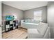 Bright bedroom with a daybed, a comfortable chair, and a TV stand for entertainment and relaxation at 10100 Sailwinds N Blvd # 105, Largo, FL 33773