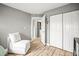 Bedroom featuring a closet, seating, and an open doorway leading to an in-unit washer and dryer at 10100 Sailwinds N Blvd # 105, Largo, FL 33773