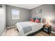 Well-lit bedroom with a cozy queen bed, accent pillows, and a convenient nightstand for personal items at 10100 Sailwinds N Blvd # 105, Largo, FL 33773