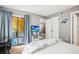 Bedroom with sliding glass doors to a balcony and view into a secondary room and large closet at 10100 Sailwinds N Blvd # 105, Largo, FL 33773