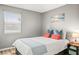 Comfortable bedroom featuring a queen bed, stylish decor, and a bright window for natural light at 10100 Sailwinds N Blvd # 105, Largo, FL 33773