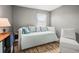 Comfortable bedroom with a daybed, decorative pillows, and a side chair for relaxing and enjoying the space at 10100 Sailwinds N Blvd # 105, Largo, FL 33773