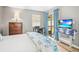 Inviting bedroom featuring a sliding door to the patio and coordinating beach-themed bedding at 10100 Sailwinds N Blvd # 105, Largo, FL 33773