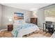 Comfortable bedroom with beach-themed decor, including a scenic ocean artwork above the bed at 10100 Sailwinds N Blvd # 105, Largo, FL 33773