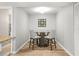 Cozy dining area with a round glass table, stylish chairs, and nautical-themed wall decor at 10100 Sailwinds N Blvd # 105, Largo, FL 33773
