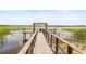 A waterfront dock with a grill, seating, and views of the lake at 10100 Sailwinds N Blvd # 105, Largo, FL 33773