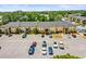 Exterior view of a multi-Gathering residence with ample parking spaces and surrounding greenery at 10100 Sailwinds N Blvd # 105, Largo, FL 33773