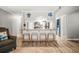Bright open kitchen featuring a breakfast bar, wood-look flooring, and decorative turtle accents at 10100 Sailwinds N Blvd # 105, Largo, FL 33773