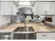 Updated kitchen with granite countertops, stainless steel appliances, and a view of the living area at 10100 Sailwinds N Blvd # 105, Largo, FL 33773
