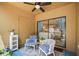Cozy outdoor patio with comfortable seating, a ceiling fan, and a sliding door leading to the interior at 10100 Sailwinds N Blvd # 105, Largo, FL 33773