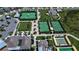 Aerial view of community amenities including tennis courts, shuffleboard, recreation fields, parking, and community center at 10420 Echo Dock Loop, San Antonio, FL 33576