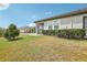 A cozy backyard, with a screen lanai, green lawn, and manicured shrubbery at 10420 Echo Dock Loop, San Antonio, FL 33576