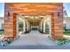 Grand entrance featuring wood and stone accents leading to glass doors with decorative floral arrangements at 10420 Echo Dock Loop, San Antonio, FL 33576