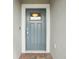 Elegant blue front door with glass inset and modern hardware at 10420 Echo Dock Loop, San Antonio, FL 33576