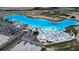 Aerial view of the community lagoon with beach access, an inflatable water park, and various other watersport activities at 10420 Echo Dock Loop, San Antonio, FL 33576