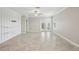 The bright living room features tile flooring, a ceiling fan, and glass doors leading outside at 10420 Echo Dock Loop, San Antonio, FL 33576
