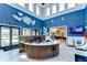 The modern lobby features blue accent walls, wood reception desk and stylish decor at 10420 Echo Dock Loop, San Antonio, FL 33576