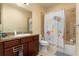Bathroom with granite countertops, shower/tub combo, and decorative shower curtain at 11308 Temperley Pl, Tampa, FL 33625
