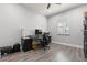 Office with a ceiling fan, wood floors, a window with shutters, and a black desk at 11308 Temperley Pl, Tampa, FL 33625