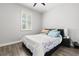 Bedroom featuring laminate flooring, neutral walls, and a window with shutters at 11308 Temperley Pl, Tampa, FL 33625