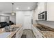Modern kitchen featuring granite countertops, stainless steel appliances, and hardwood flooring at 11308 Temperley Pl, Tampa, FL 33625