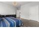 Bright main bedroom with hardwood floors, modern lighting, and ample closet space at 11308 Temperley Pl, Tampa, FL 33625