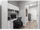 Well-lit office space with built-in shelving, desk, and adjacent laundry room at 11308 Temperley Pl, Tampa, FL 33625