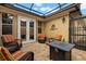 View of screened lanai with four wicker chairs and outdoor lighting at 11308 Temperley Pl, Tampa, FL 33625