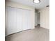 Neutral bedroom with a large closet, beige walls, tiled flooring, and a bright recessed ceiling light fixture at 115 S Saturn Ave, Clearwater, FL 33755
