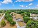 Scenic aerial of home and neighborhood, featuring mature trees and spacious land at 11514 Sun Rd, Dade City, FL 33525