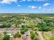 Lovely aerial view of established community with lush landscaping and blue skies at 11514 Sun Rd, Dade City, FL 33525