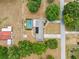 Beautiful aerial view of home with solar panels, and a private screened-in pool at 11514 Sun Rd, Dade City, FL 33525