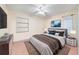 Cozy bedroom with warm color palette, ceiling fan, window and television at 11514 Sun Rd, Dade City, FL 33525