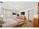 Bright bedroom with bed, modern furniture, a ceiling fan, and a door to the outside at 11514 Sun Rd, Dade City, FL 33525