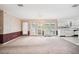 Dining area with chandelier, glass doors, and view into the kitchen at 11514 Sun Rd, Dade City, FL 33525