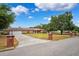 Brick home with manicured lawn, brick mailbox posts, and ample parking on a wide driveway at 11514 Sun Rd, Dade City, FL 33525