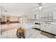 Bright kitchen with white cabinets, an island with seating, and tile flooring at 11514 Sun Rd, Dade City, FL 33525
