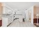 Bright kitchen with white cabinets, an island with seating, and tile flooring at 11514 Sun Rd, Dade City, FL 33525