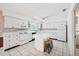 Bright kitchen with white cabinets, an island with seating, and tile flooring at 11514 Sun Rd, Dade City, FL 33525