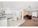 Bright kitchen with white cabinets, tile flooring, and an island with bar seating at 11514 Sun Rd, Dade City, FL 33525